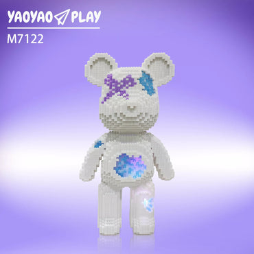 A white ​​Brick Bear toy​​ with purple-blue accents labeled "M7122" against a gradient backdrop.
